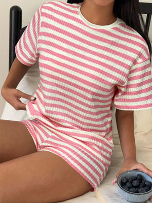 Pink and white striped waffle knit two-piece loungewear set with crew neck top and shorts.