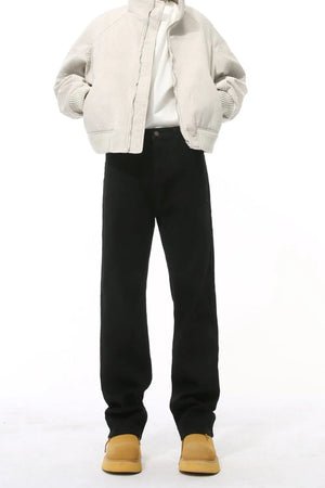Split-hem tailored black denim jeans with a straight leg cut.