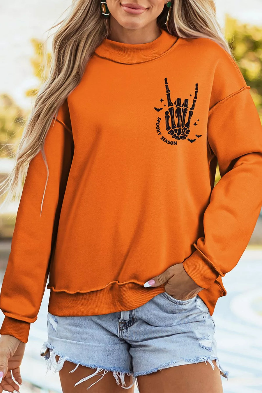 orange sweatshirt with exposed seam and long sleeve