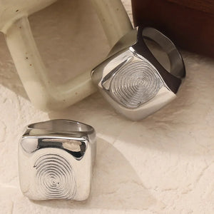 Silver signet ring with sculpted fingerprint detail, casual accessory