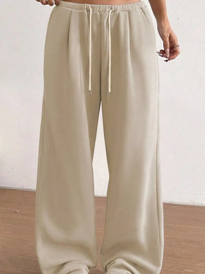 Tan wide-leg maternity joggers with drawstring waist and pockets.