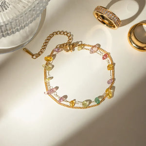Gold double chain bracelet with colorful gemstone accents and adjustable clasp