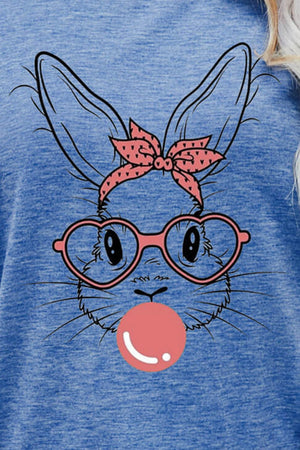 Misty Blue t-shirt with a graphic of a bunny wearing pink heart glasses and a pink polka dot bow, blowing a pink bubble.