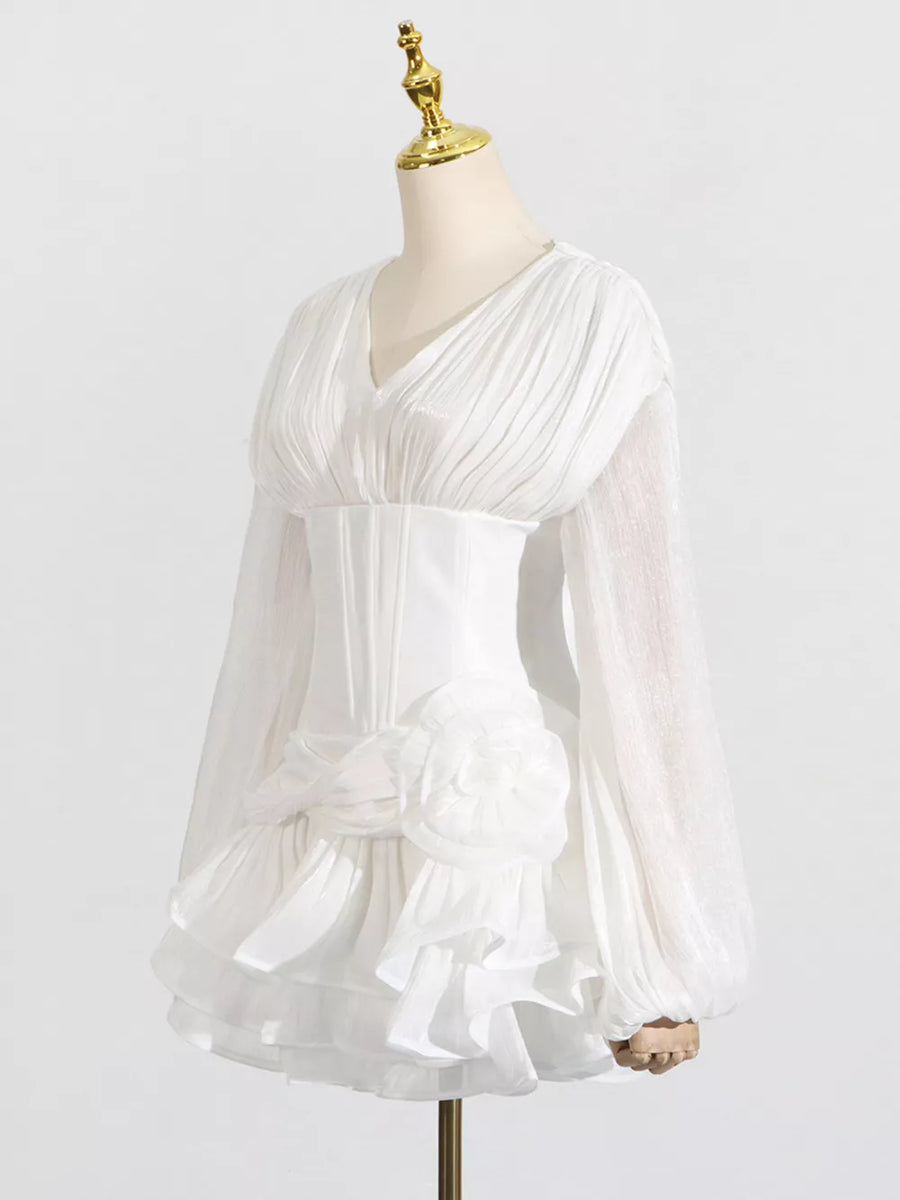 White ruffle mini dress with balloon sleeves, ruched bodice, and floral detail