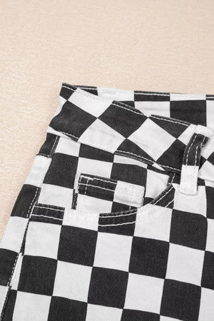 Checkerboard distressed cropped jeans in black and white denim with visible stitching details.
