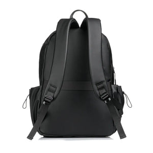 Black canvas laptop backpack with adjustable straps and side pockets.