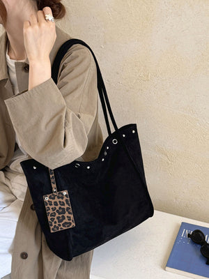 tote in black featuring studded and boxy fit
