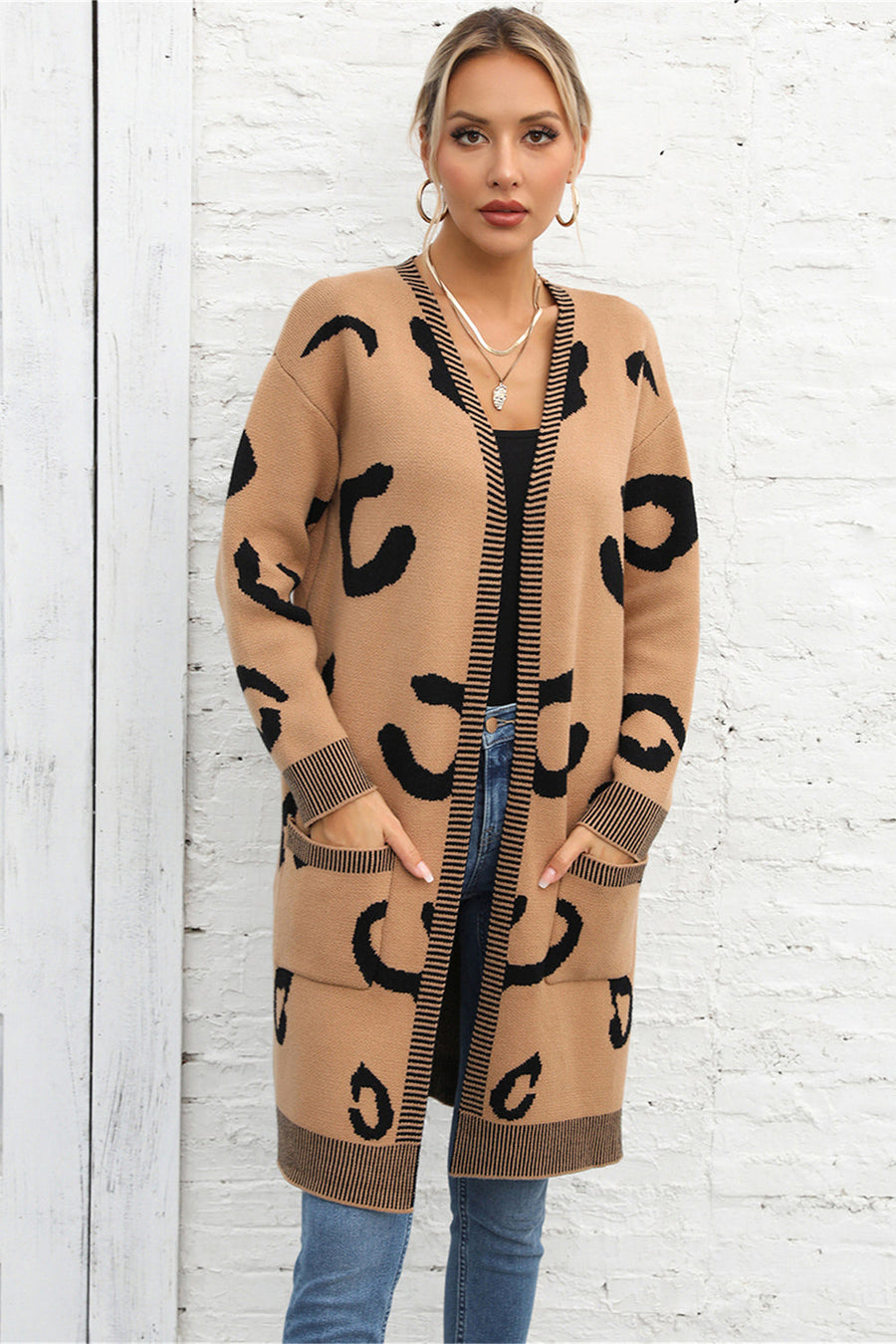 Khaki leopard print knit cardigan with black striped trim and pockets.