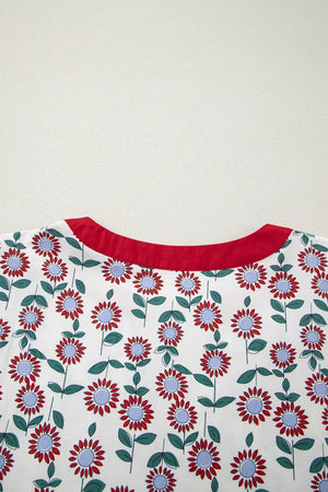 Vibrant floral tiered midi dress with red floral pattern and red neckline.