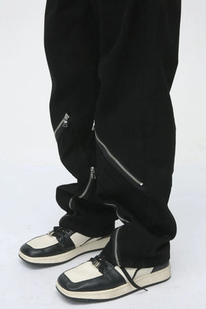 Dark straight leg jeans with multiple zip details on the legs.