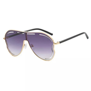 Statement aviator sunglasses with gold metal frames and purple gradient lenses.