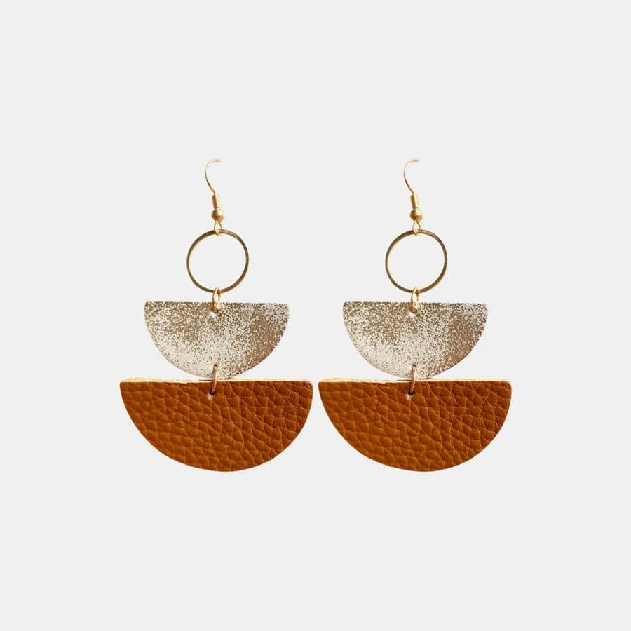 Textured leather and metallic half-moon earrings in caramel and gold.