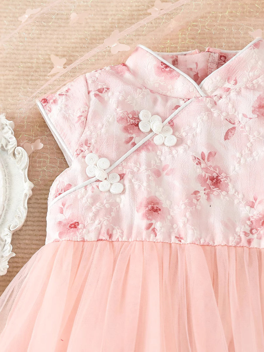 Pink floral cap sleeve baby dress with mandarin collar and decorative knots.