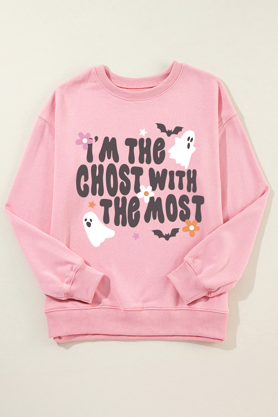 Blush pink crewneck sweatshirt with a spooky ghost and bat graphic and text that reads "I'm the ghost with the most.