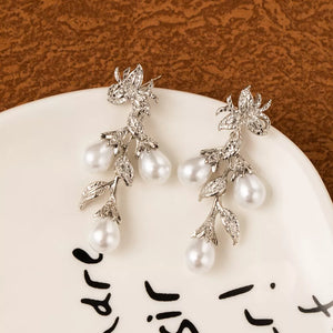 white earrings featuring dangling and floral