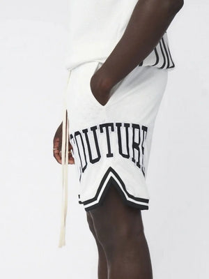 White mesh athletic shorts with black trim and "COUTURE" graphic detail