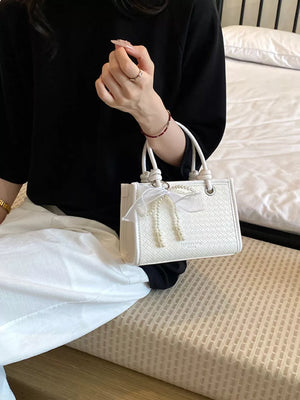 crossbody bag in Pastel Blue with geometric and bow embellishment