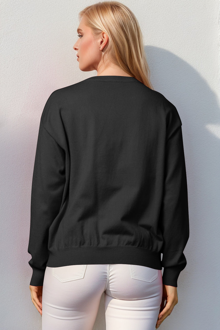 Black crewneck sweater with elasticized hem and cuffs, acrylic knit.
