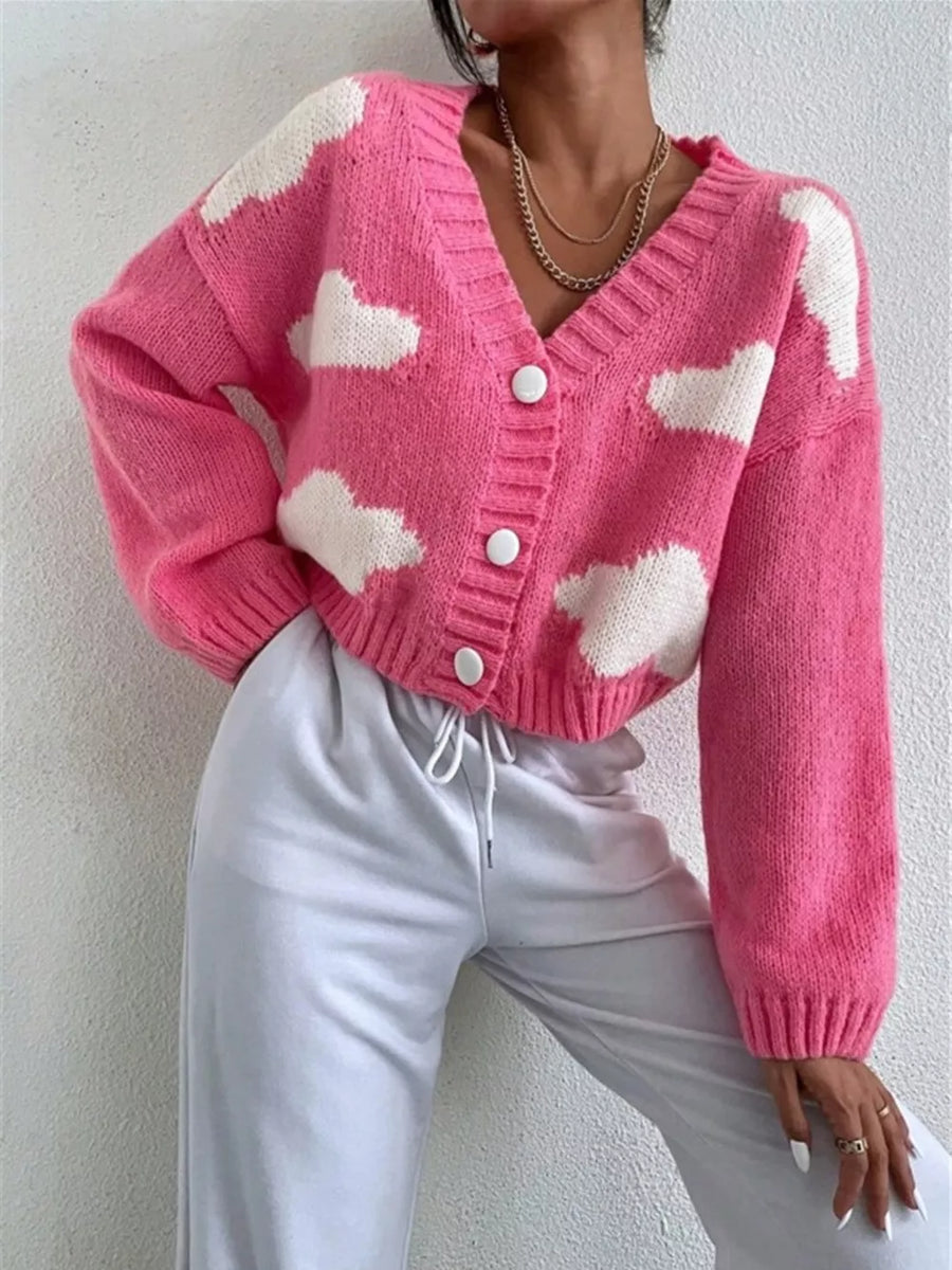 Hot pink acrylic button cardigan with white cloud pattern, V-neck, long sleeves.