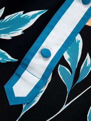Black floral print button-down blouse with bubble sleeves, featuring a white collar with blue trim and blue buttons.