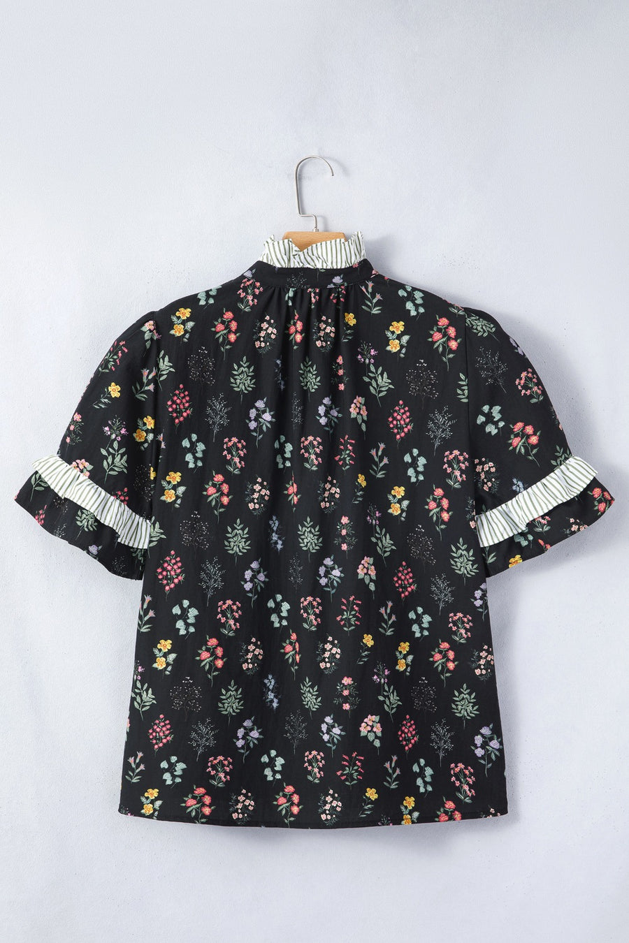 Black cotton floral short sleeve blouse with ruffled striped cuffs and mock neck