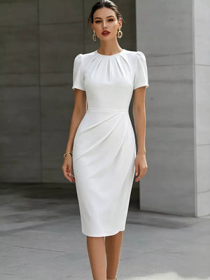 White midi dress with ruched waist, pleated neckline, and short puff sleeves.