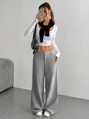 Chic grey corduroy wide-leg trousers with front pockets and a comfortable fit.
