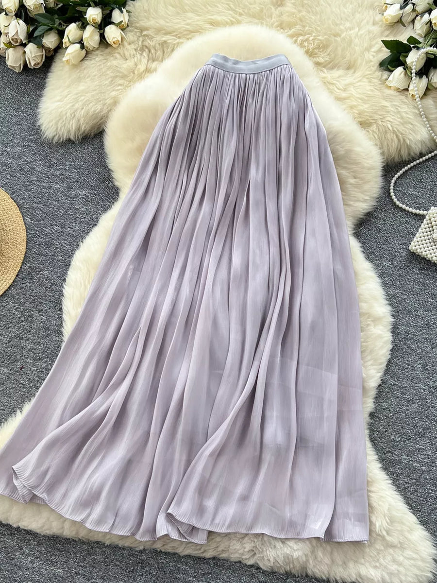 Pleated maxi skirt in light purple with a flowing, elegant silhouette.