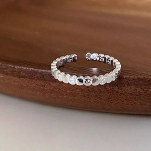 black ring featuring adjustable and ditsy floral