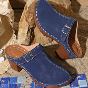 Blue round toe platform slip-on clogs with buckle detail and contrast stitching.