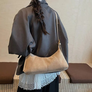 Chic suede crescent shoulder bag in Khaki with adjustable strap.