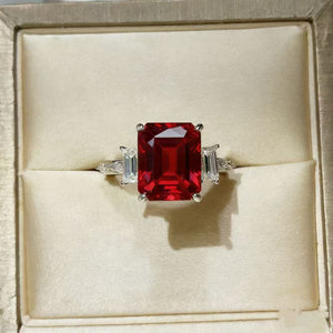 Sterling silver ring with large emerald-cut red moissanite and baguette side stones