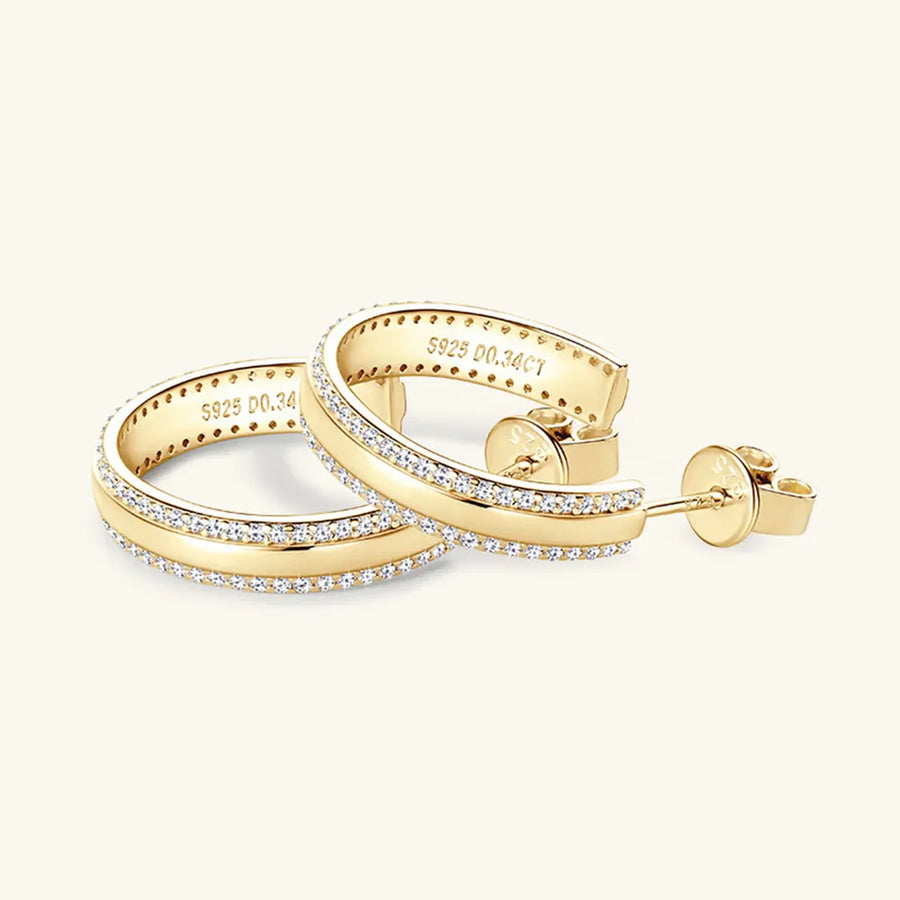 Gold pavé moissanite C-hoops in sterling silver with diamond accents.