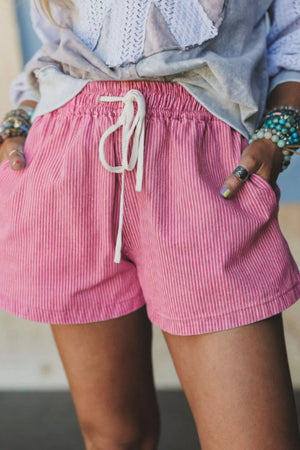 Pink striped denim shorts with drawstring waist and pockets