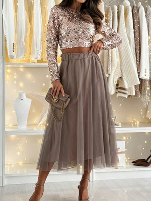 Sheer mesh A-line midi skirt in taupe with elastic waistband, flowing elegantly.