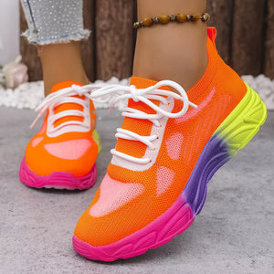 Orange red mesh lace-up sneakers with a pink, purple, and yellow gradient sole.