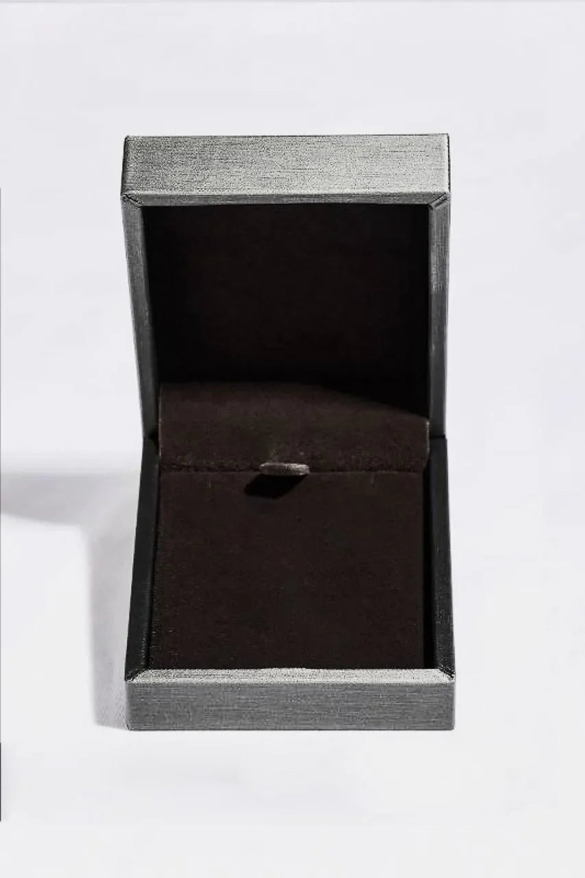 Open jewelry box with grey textured exterior and dark interior.