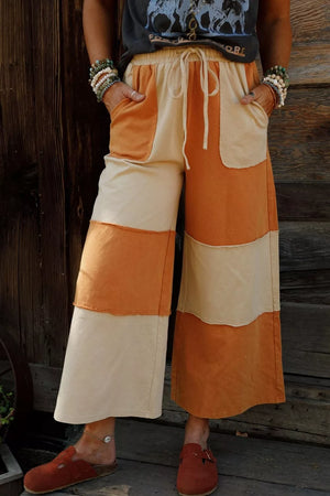 wide-leg pants in rust featuring drawstring waist and flared fit