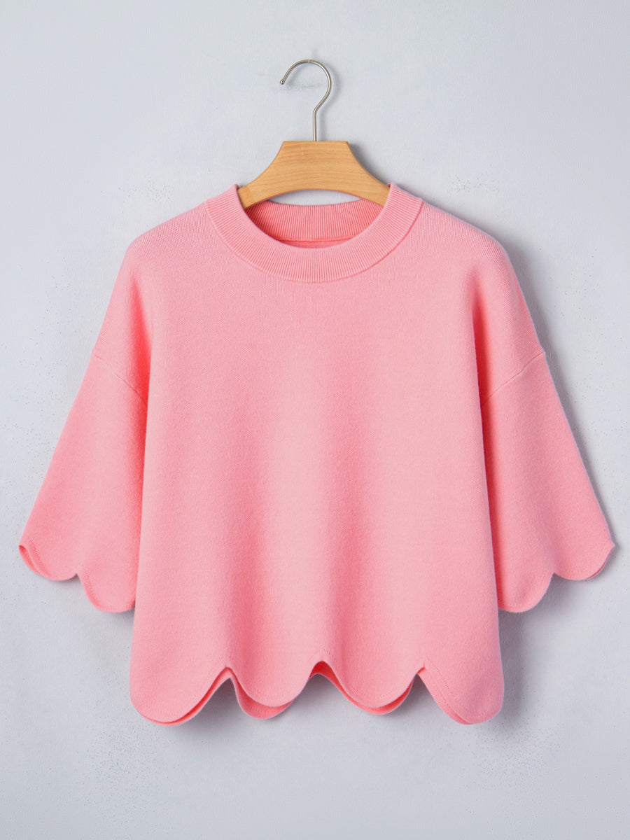 Pink knit top with scalloped hem and sleeves
