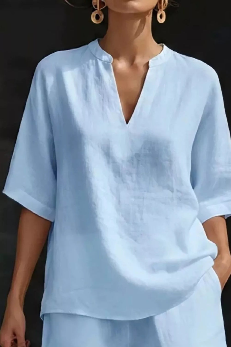 Light blue notched top with V-neck and short sleeves, part of a loungewear set.