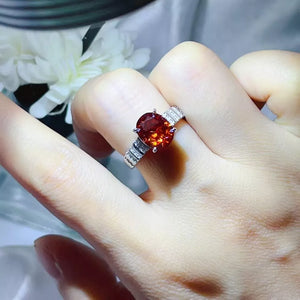 ring in red-orange featuring oval cut moissanite and solitaire fit