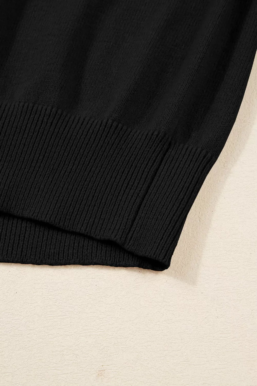 Black acrylic knit sweater with ribbed hem detail