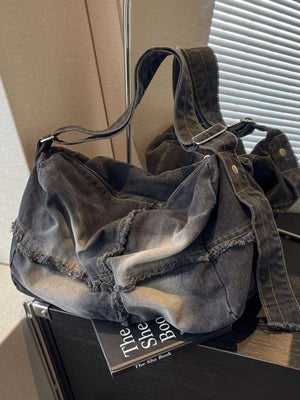 Dark frayed denim slouch crossbody bag with adjustable strap