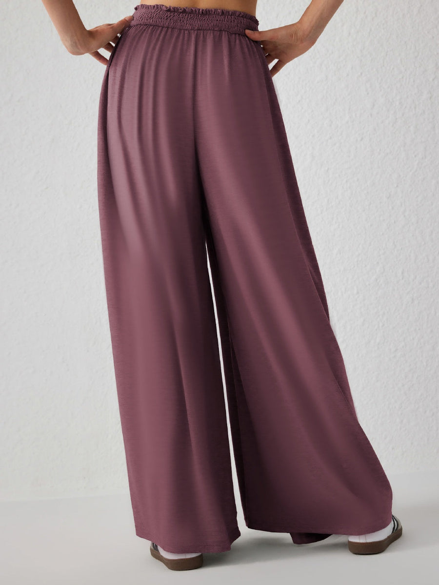 Drape-front wide-leg jersey trousers in Moonlit Mauve with a smocked waistband.