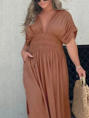 Brown V-neck maxi dress with smocked waist and dolman sleeves, featuring pockets.