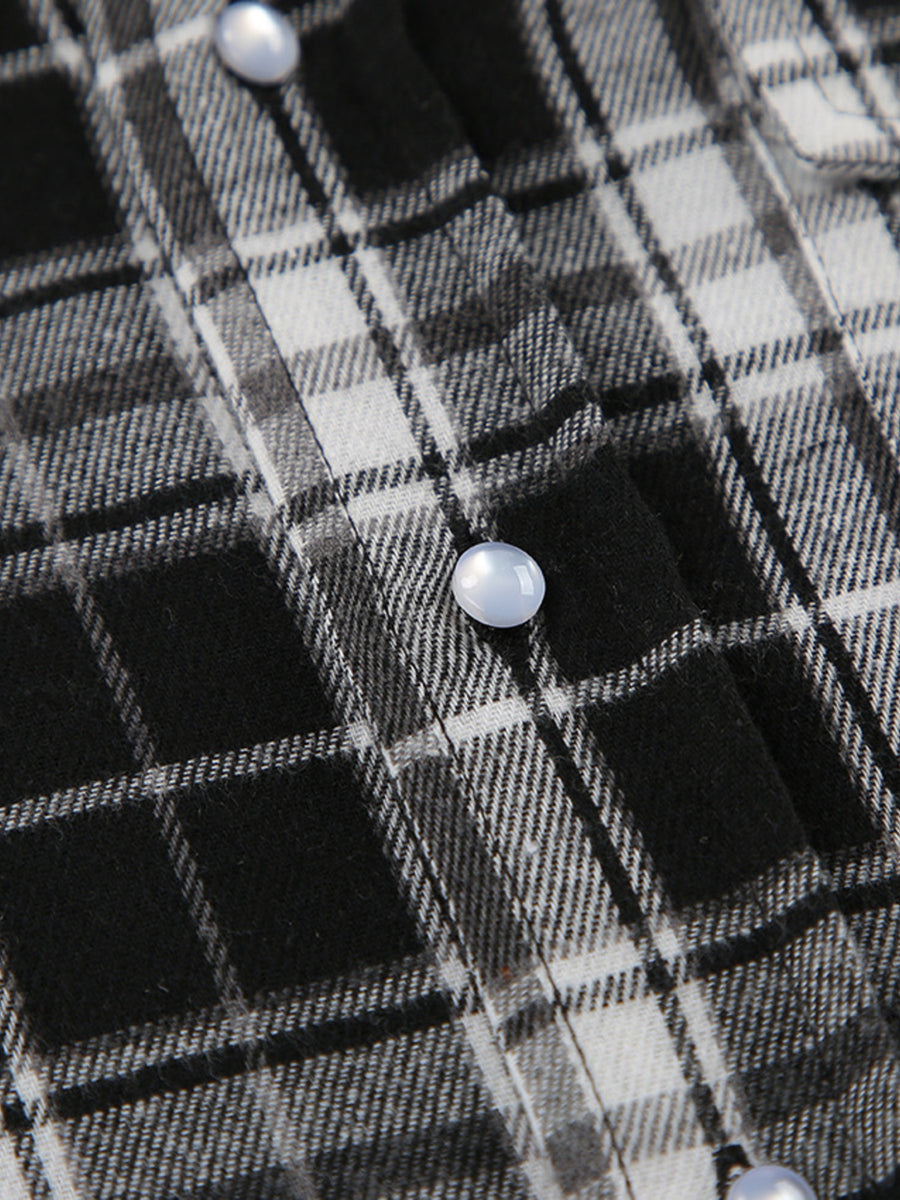 Oversized button-up shirt in black and white plaid cotton with pearl buttons.