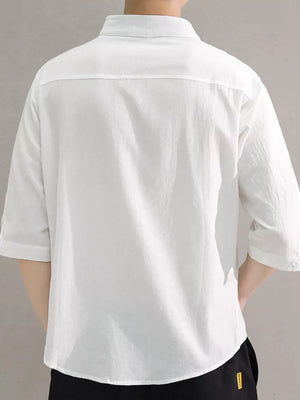 White cotton button-down shirt with roll-up sleeves and a chest pocket.