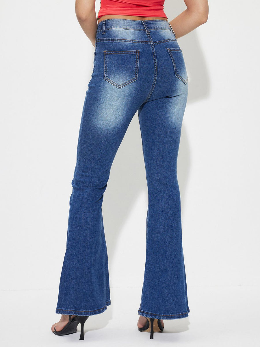 Mid-rise flared denim jeans in medium wash cotton with whiskering detail.