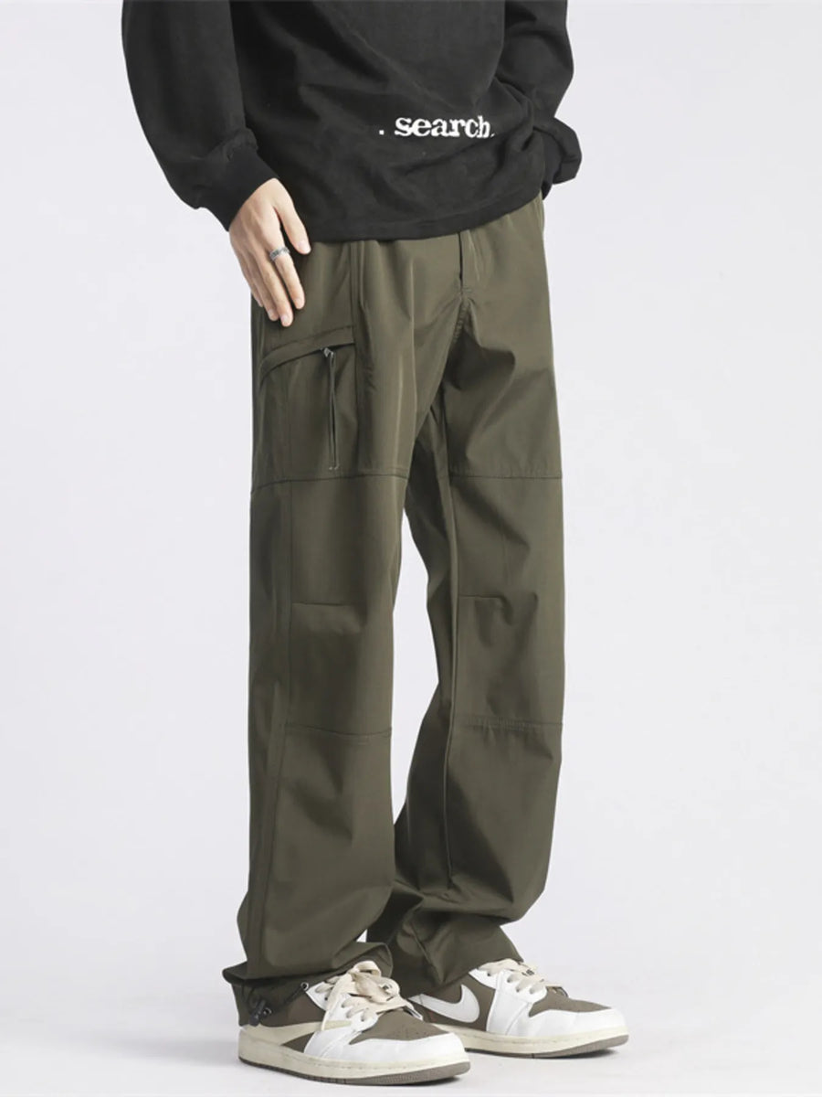 Relaxed fit green cargo pants with zip pocket detail and casual styling.