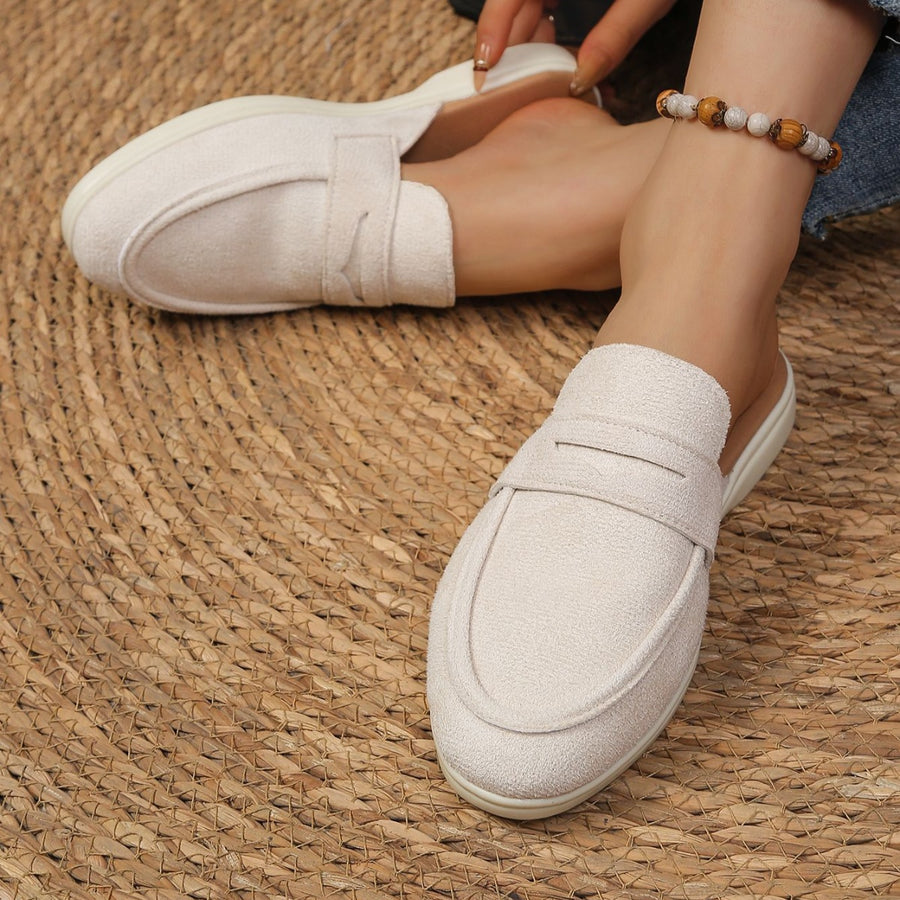 Textured round toe slip-on loafers in off-white with a backless design and strap detail.